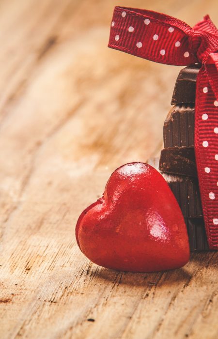 Chocolate with ribbon and heart on St. Valentine's day love.